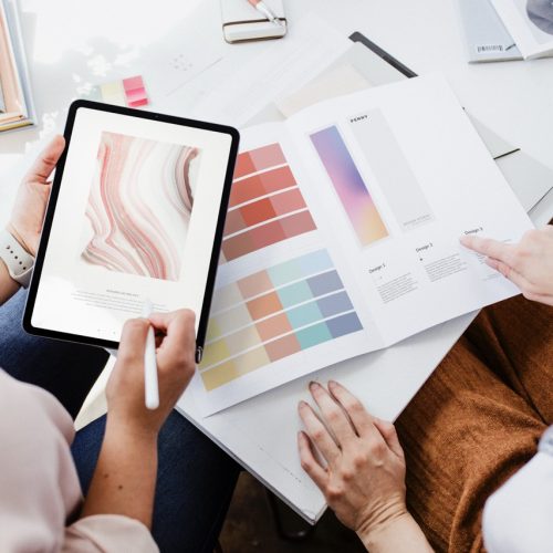 Women choosing a color scheme using a digital tablet